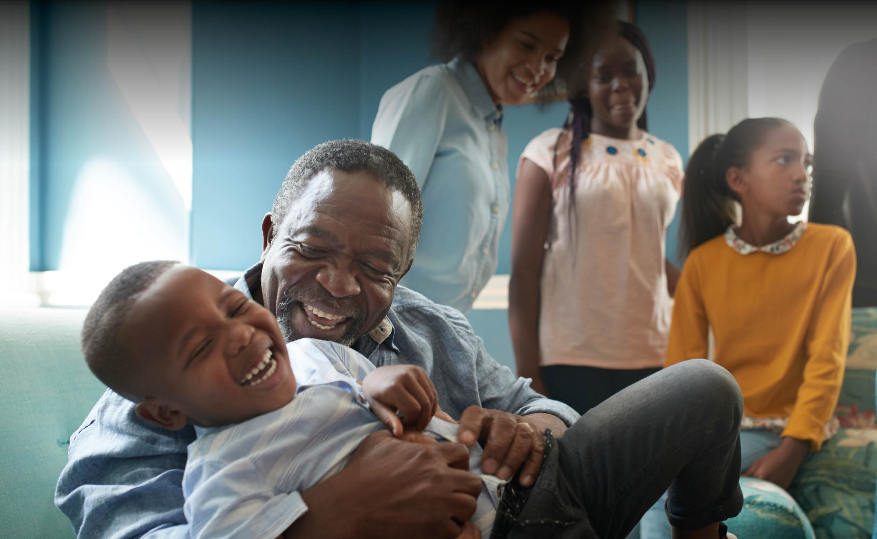 Protect : Consumer Duty - An image of a family sat laughing