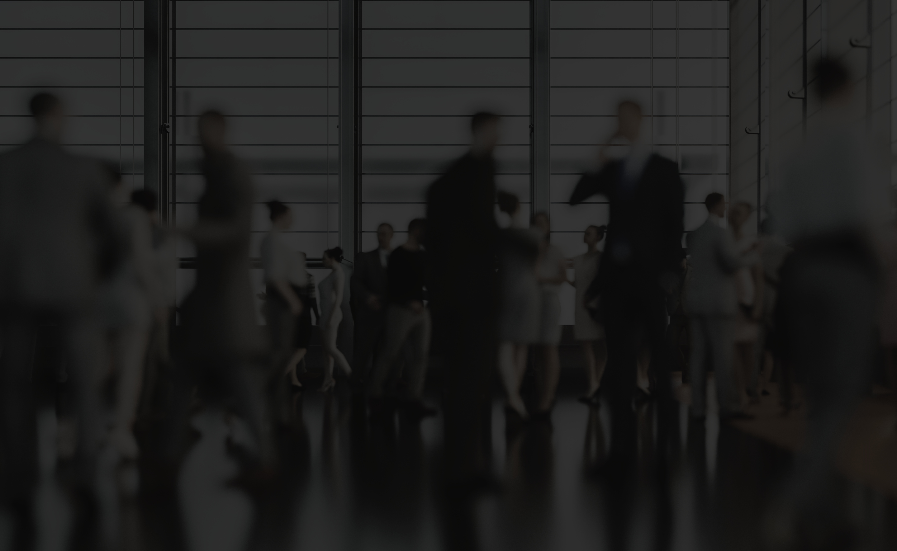 Fundamental Science To Fintech blurred black and white image of men and women walking and talking